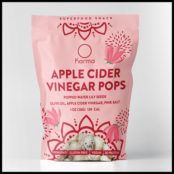Pink package of Karma Apple Cider Vinegar Pops on a light gray background